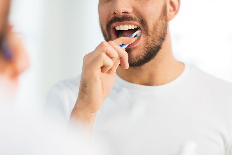 male brushing teeth